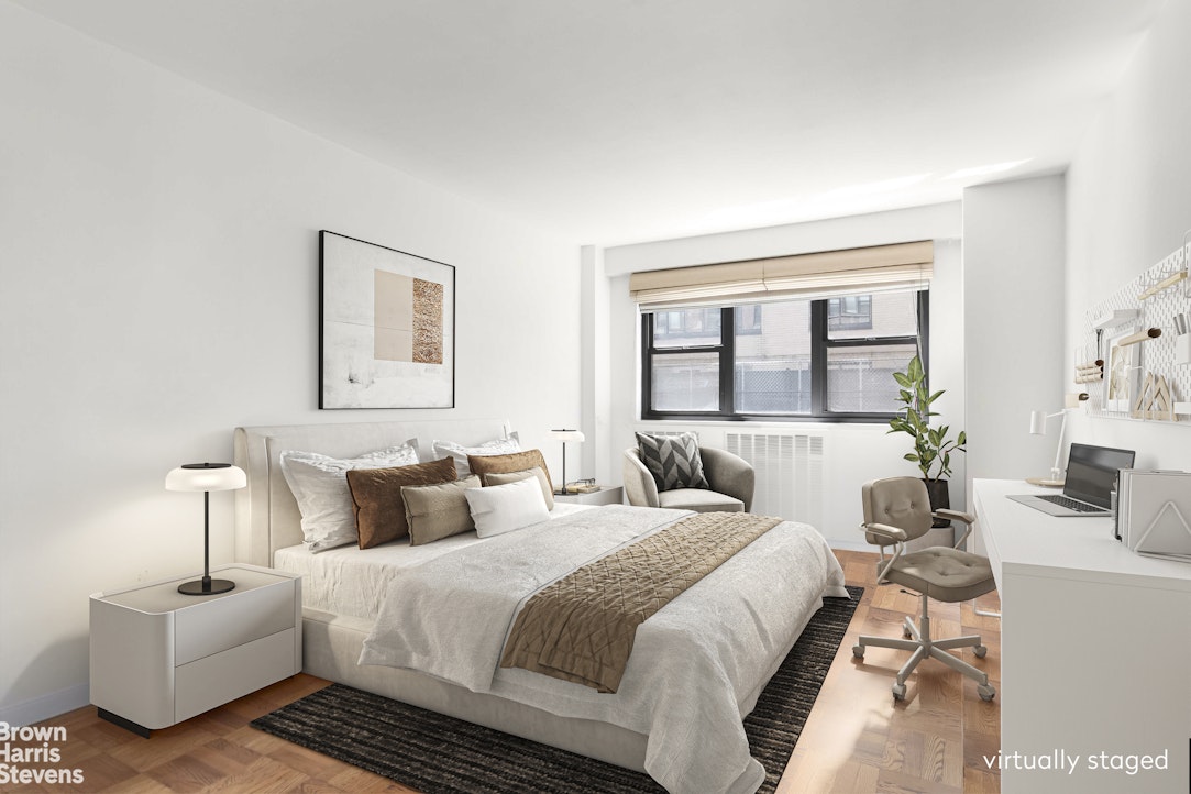 340 East 74th Street, Unit 1J Manhattan, NY 10021 - Photo 4 of 6 a bedroom with bed and a large window