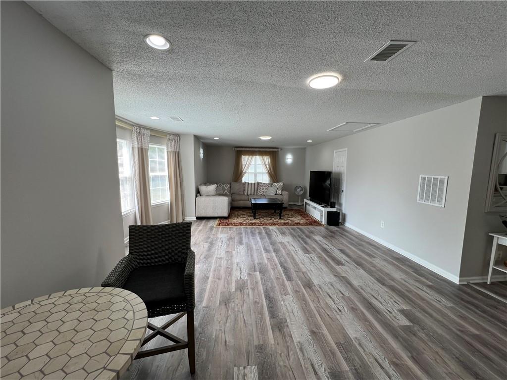 509 Vaughan Valley View Hampton, GA 30228 - Photo 11 of 38 a living room with furniture and a wooden floor