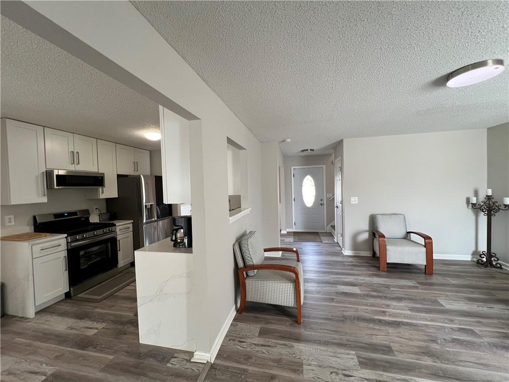 509 Vaughan Valley View Hampton, GA 30228 - Photo 15 of 38 a living room with furniture a dining table and kitchen view