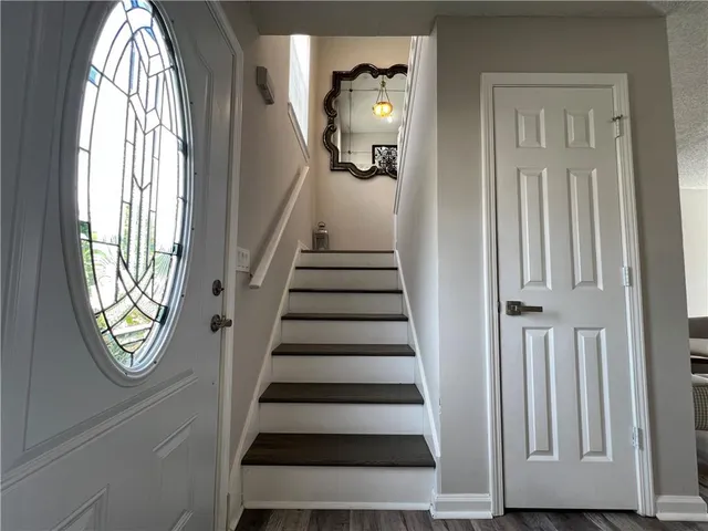 a view of an entryway with wooden floor
