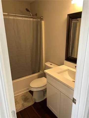 a bathroom with a sink a toilet a mirror and shower