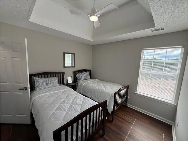 a bedroom with two beds and a window