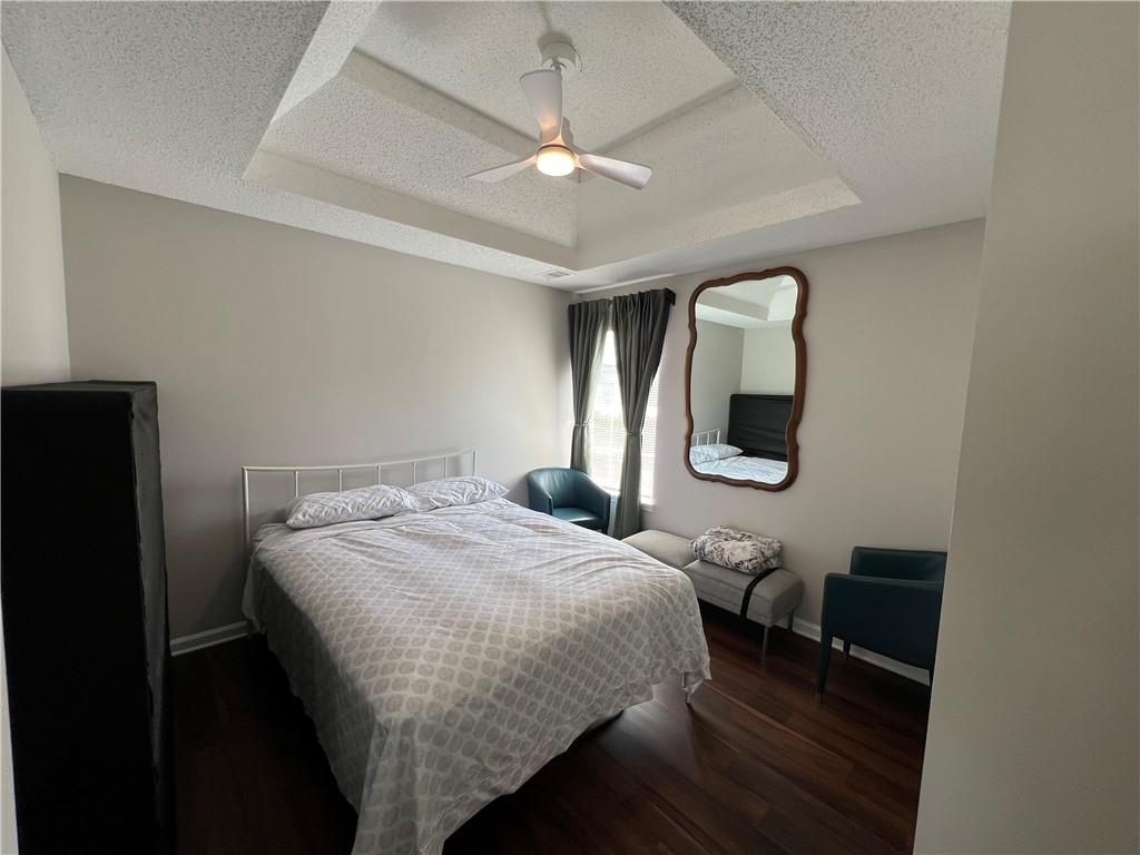 509 Vaughan Valley View Hampton, GA 30228 - Photo 21 of 38 a bedroom with a bed a mirror and a window