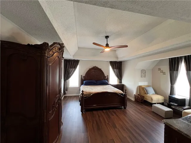a living room with furniture and a ceiling fan