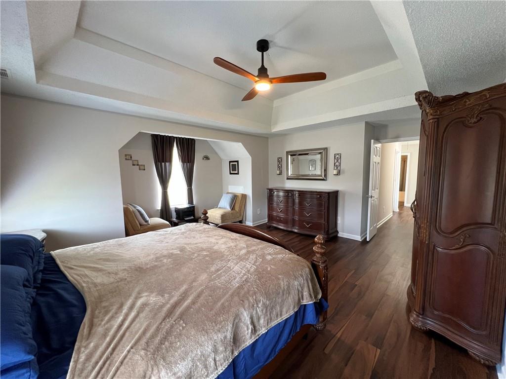 509 Vaughan Valley View Hampton, GA 30228 - Photo 26 of 38 a spacious bedroom with a bed and wooden floor