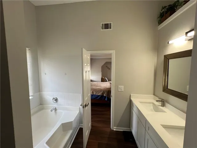 a en suite bathroom with a sink a bathtub and a toilet