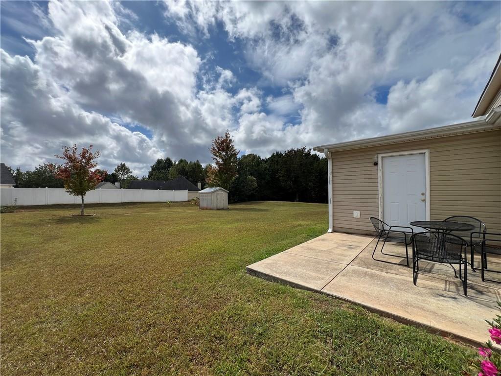 509 Vaughan Valley View Hampton, GA 30228 - Photo 35 of 38 a backyard of a house with table and chairs