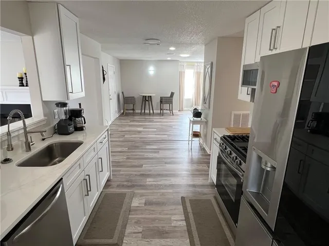 a kitchen with a sink stove and refrigerator