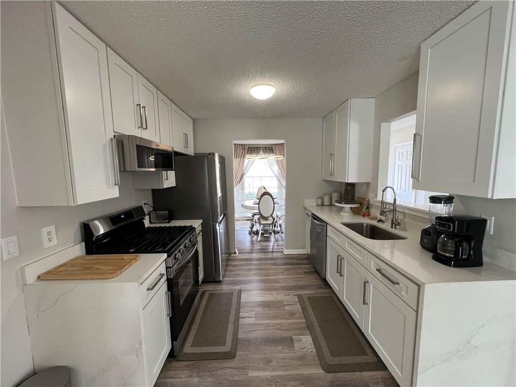 509 Vaughan Valley View Hampton, GA 30228 - Photo 7 of 38 a kitchen with a sink stove and cabinets