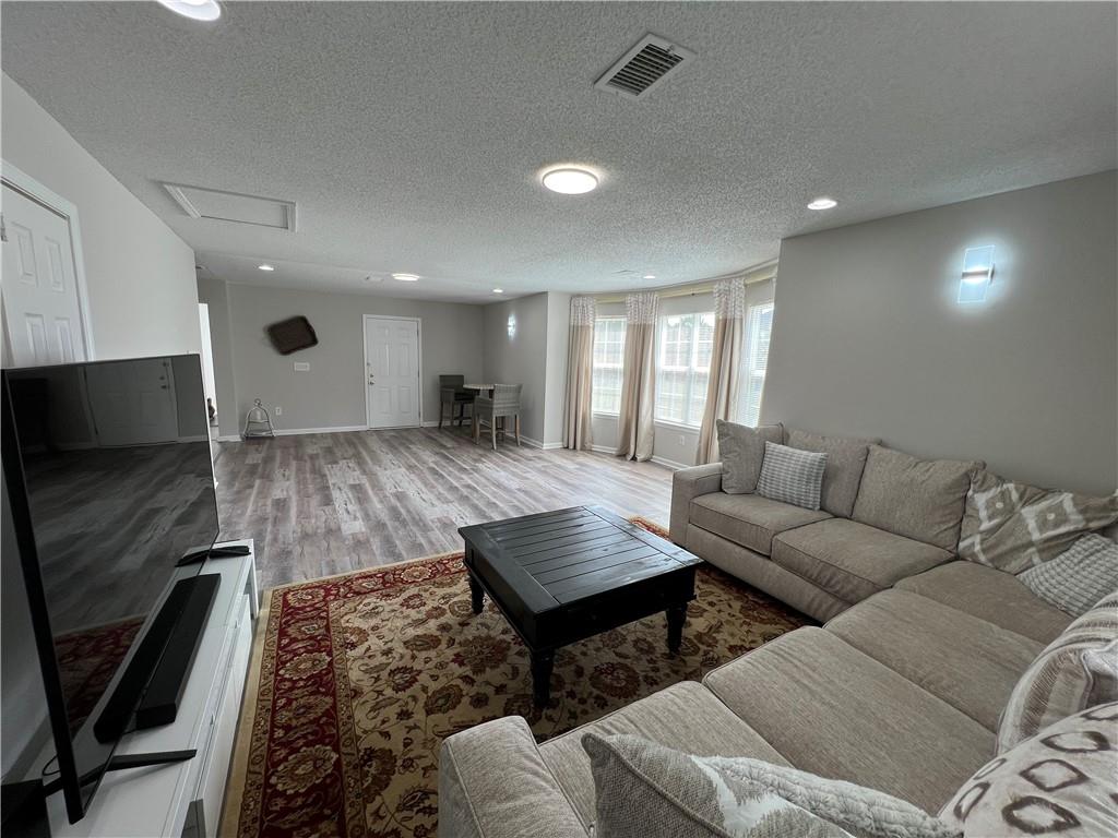 509 Vaughan Valley View Hampton, GA 30228 - Photo 8 of 38 a living room with furniture and a flat screen tv