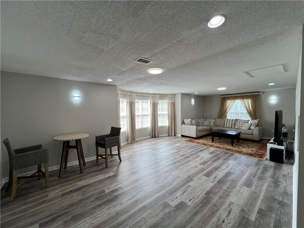 509 Vaughan Valley View Hampton, GA 30228 - Photo 10 of 38 a living room with furniture and a wooden floor