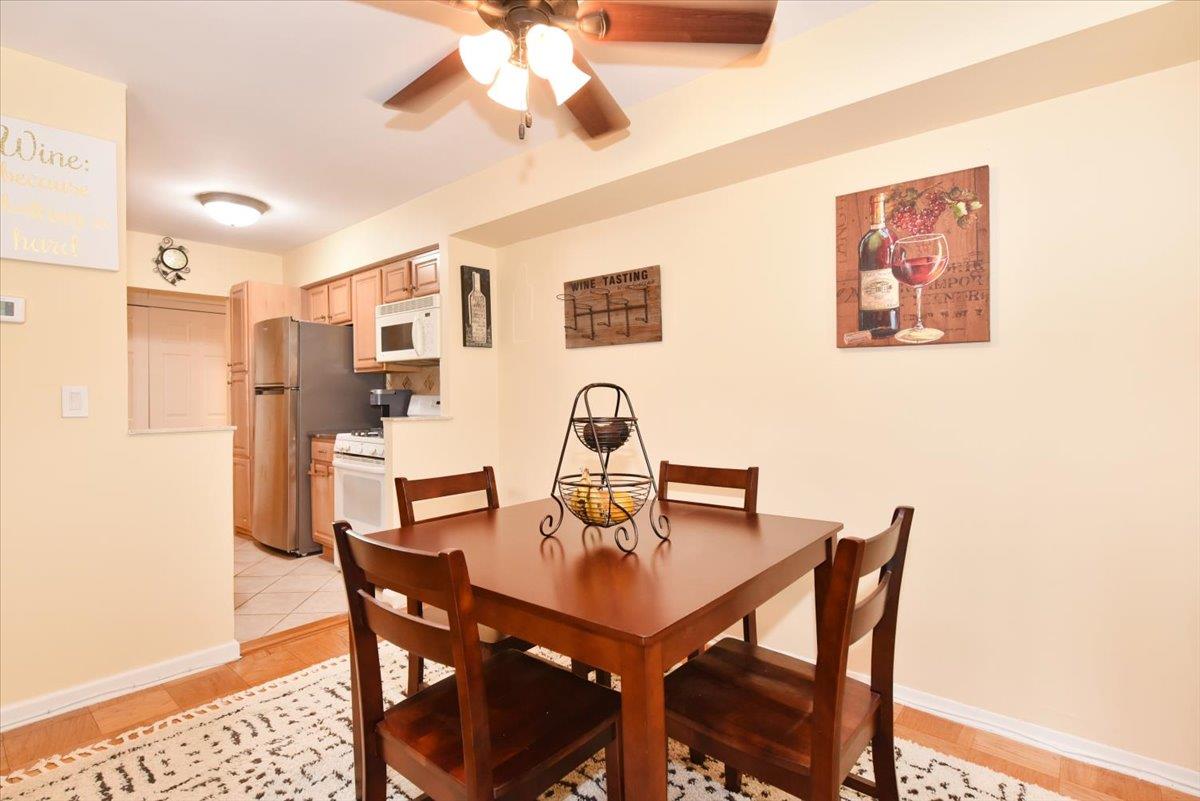 320 East Shore Road, Unit 10C Great Neck, NY 11023 - Photo 16 of 30 Dining area with a ceiling fan and light wood-type flooring
