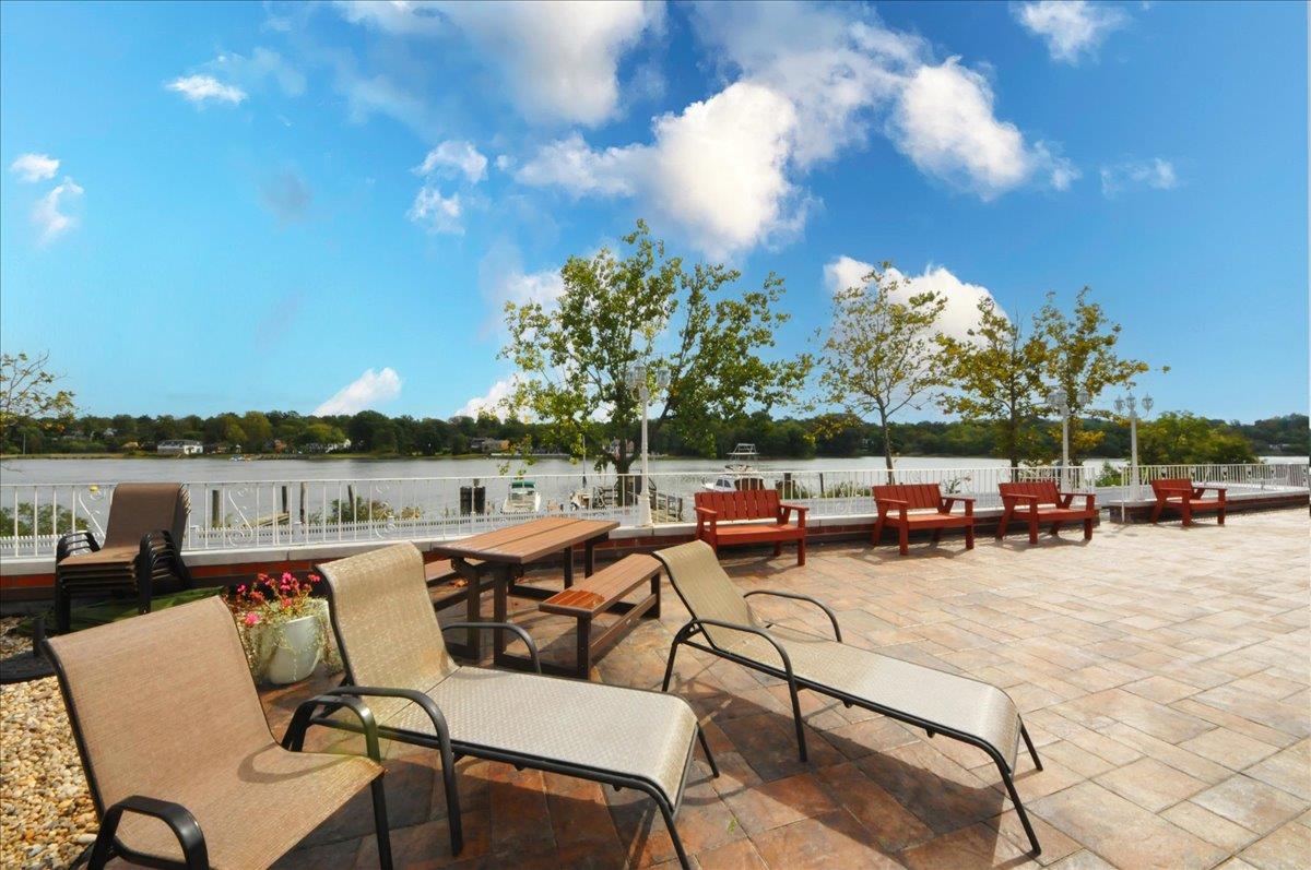 320 East Shore Road, Unit 10C Great Neck, NY 11023 - Photo 28 of 30 View of patio / terrace with a water view and outdoor dining area