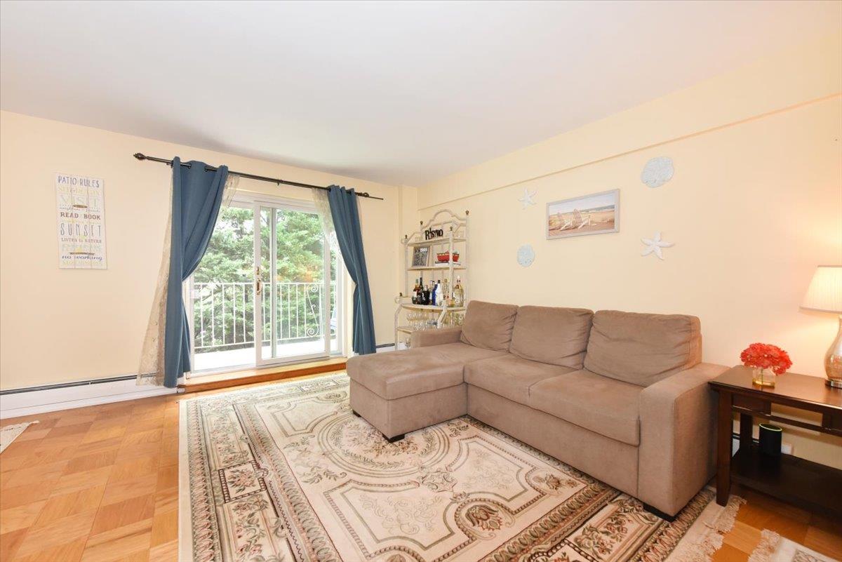 320 East Shore Road, Unit 10C Great Neck, NY 11023 - Photo 10 of 30 Living room featuring baseboard heating