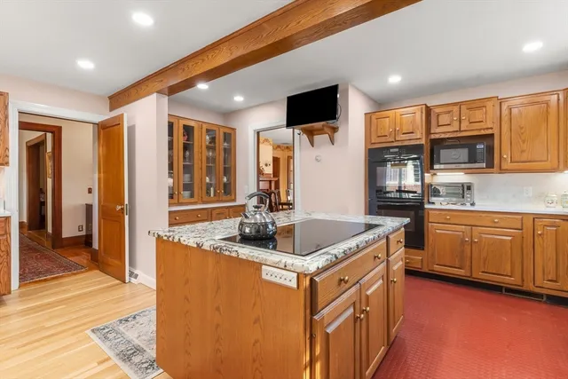 a kitchen with stainless steel appliances granite countertop a sink stove and cabinets