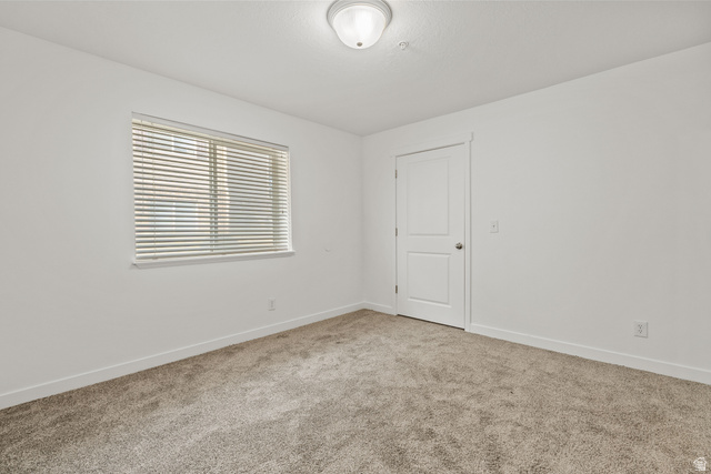8204 North Cedar Springs Road, Unit 2 Eagle Mountain, UT 84005 - Photo 11 of 17 Carpeted spare room featuring baseboards