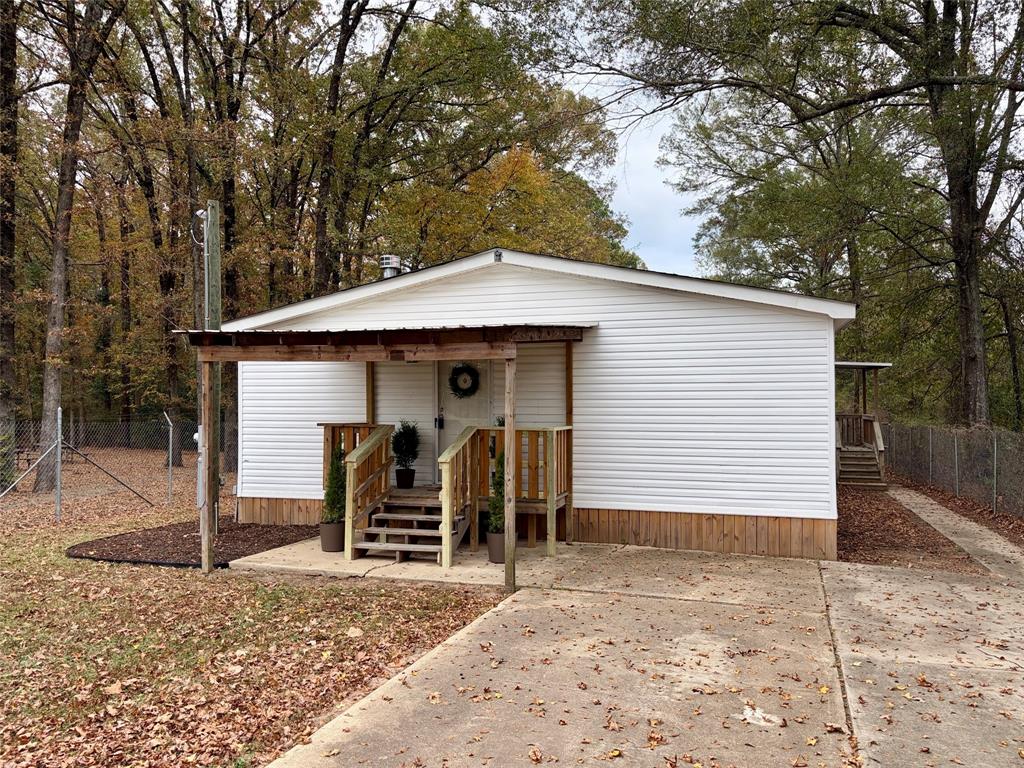 6913 Rice Road Shreveport, LA 71129 - Photo 3 of 26 a front view of a house with a yard and garage
