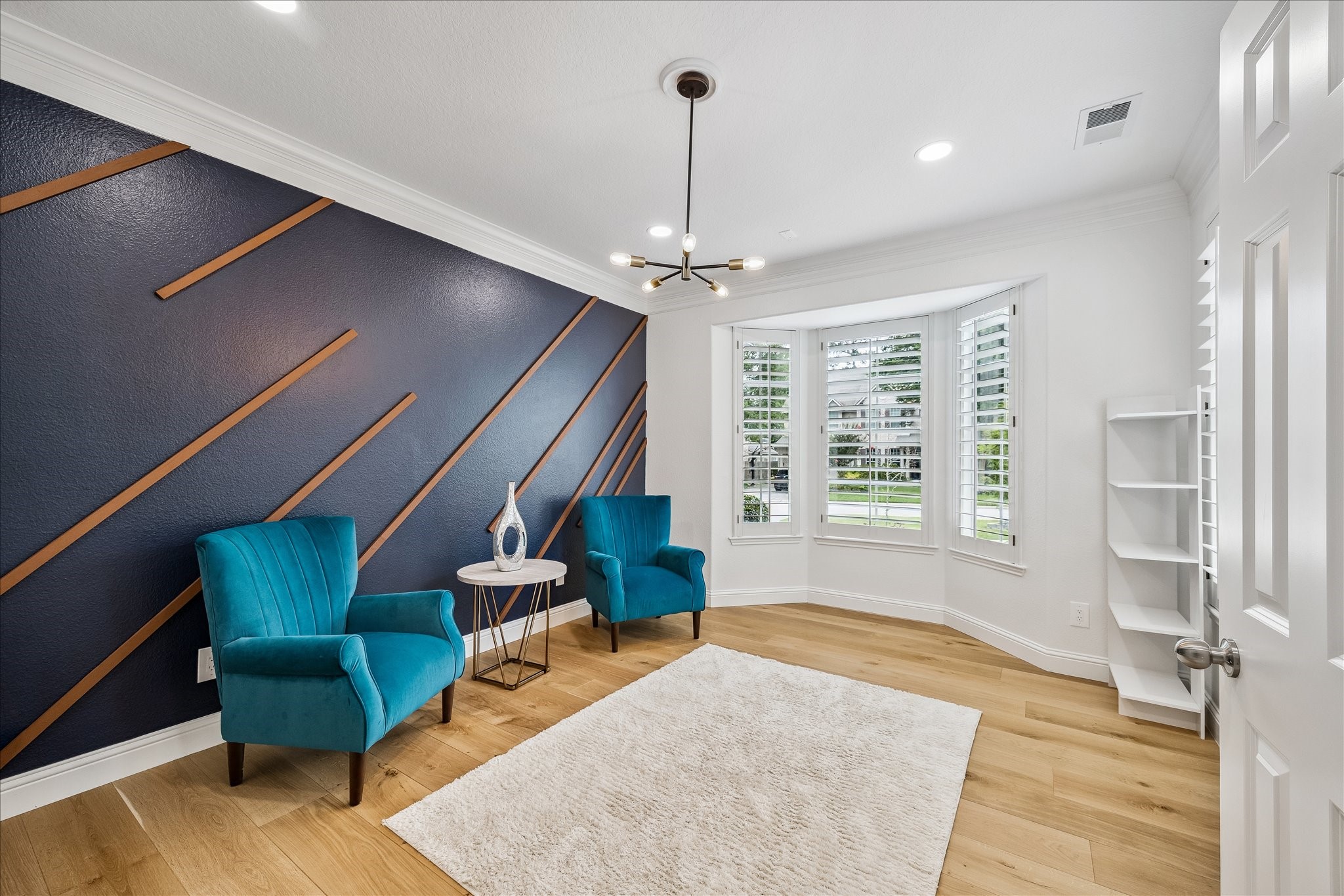15 West Beckonvale Circle The Woodlands, TX 77382 - Photo 7 of 44 A front-facing flex room, which could serve as a study or formal living room, showcases large windows framed with plantation shutters and a lovely view of the gated courtyard.