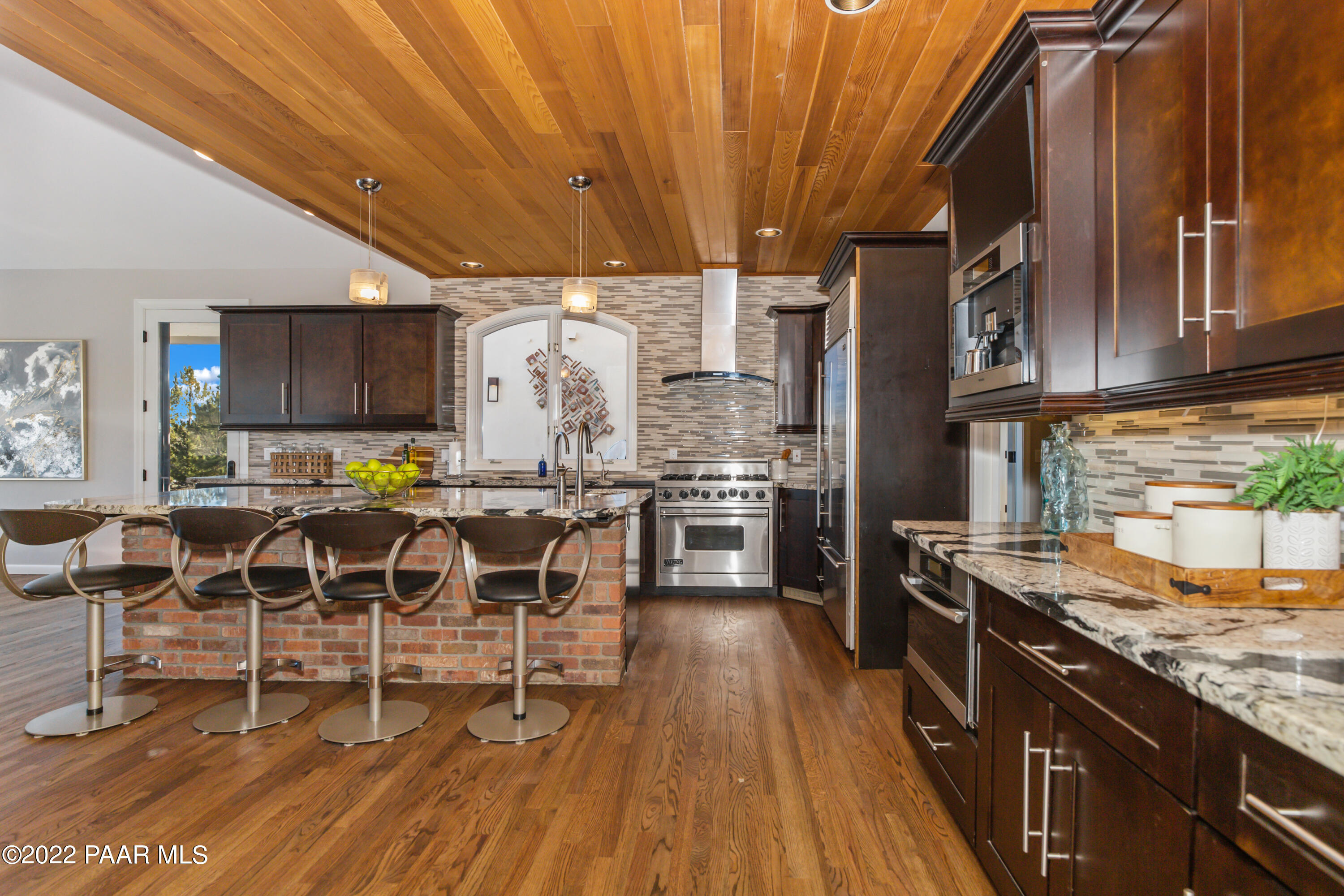 3000 Shadow Valley Ranch Road Prescott, AZ 86305 - Photo 13 of 54 a kitchen with stainless steel appliances granite countertop a table chairs sink and cabinets