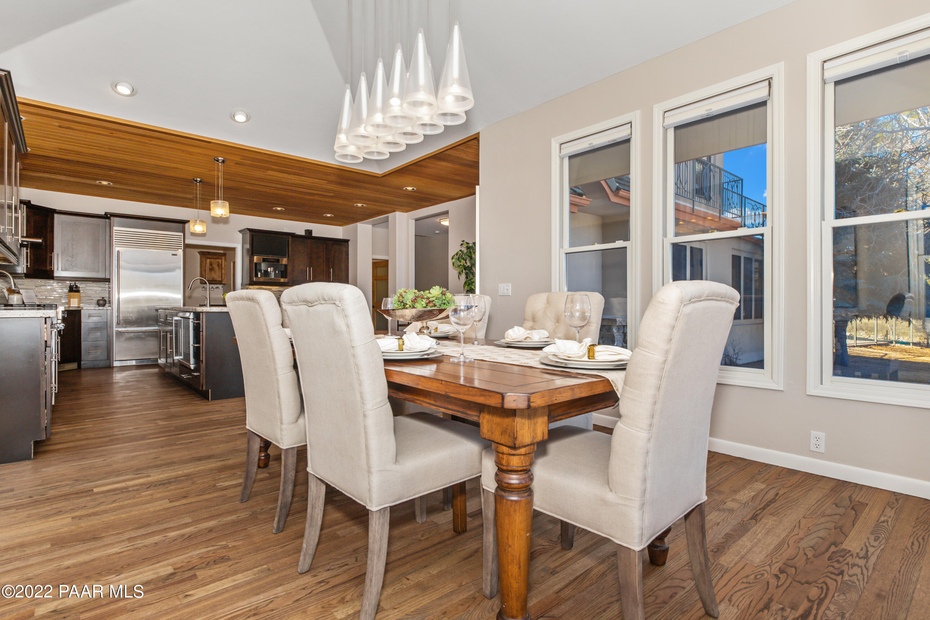 3000 Shadow Valley Ranch Road Prescott, AZ 86305 - Photo 16 of 54 a dining room with furniture a chandelier and wooden floor