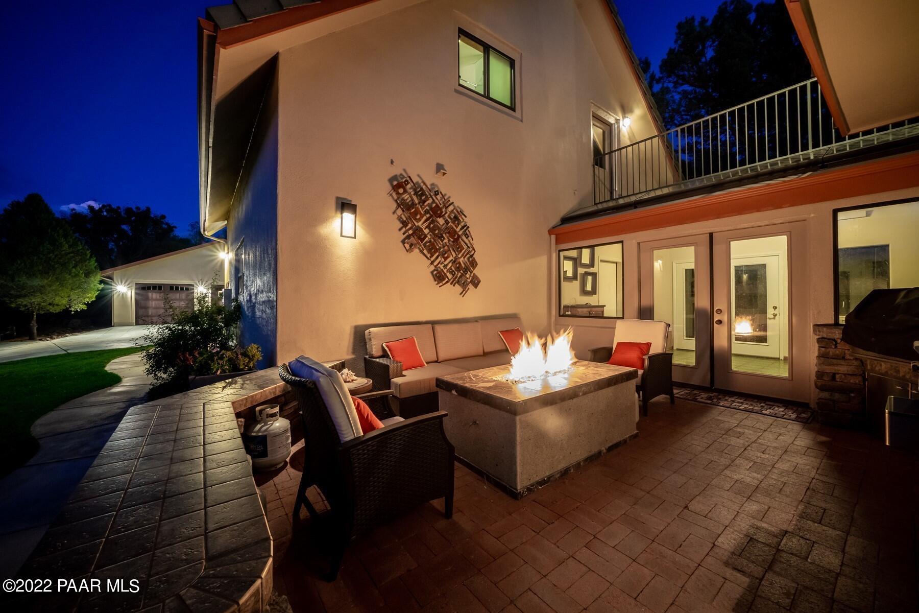 3000 Shadow Valley Ranch Road Prescott, AZ 86305 - Photo 51 of 54 a living room with furniture a rug and a fireplace