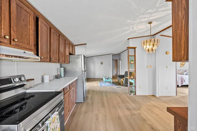 a kitchen with granite countertop a sink stove and cabinets