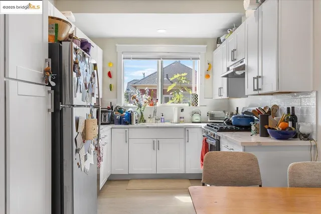 a kitchen with stainless steel appliances granite countertop a refrigerator and a sink