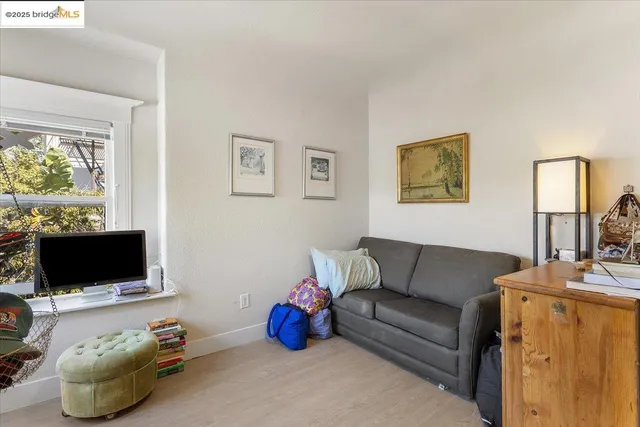 a living room with furniture a flat screen tv and a window