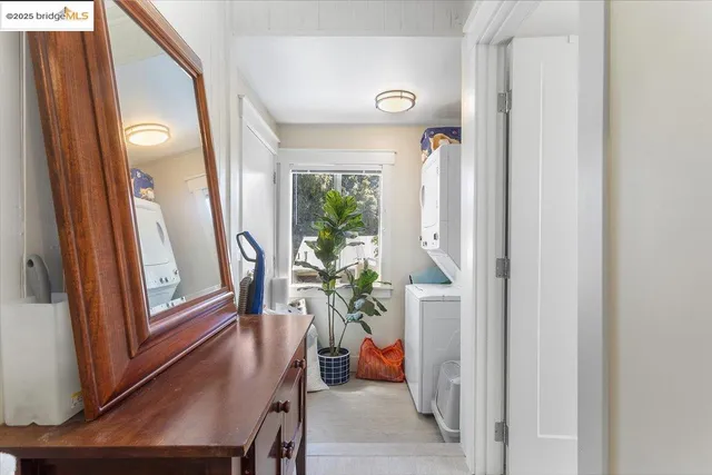 a view of a hallway with furniture and a potted plant