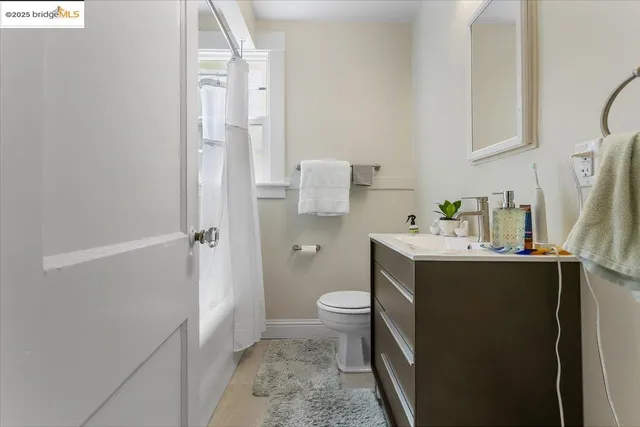 a view of bathroom with a sink and mirror