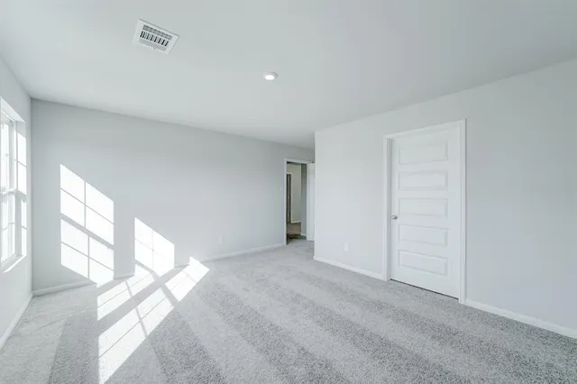 a view of an empty room and a window