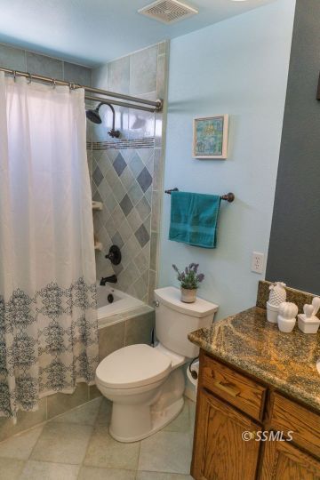 718 La Paloma Street Ridgecrest, CA 93555 - Photo 37 of 50 a bathroom with a granite countertop toilet sink and mirror