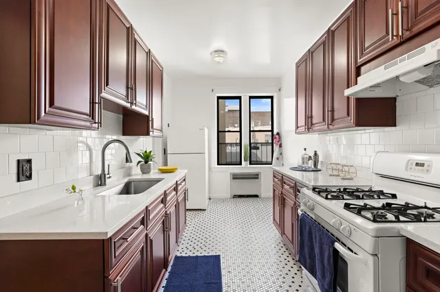 a kitchen with stainless steel appliances granite countertop a sink stove and cabinets