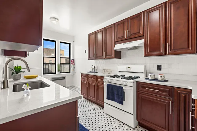 a kitchen with a sink a stove and cabinets