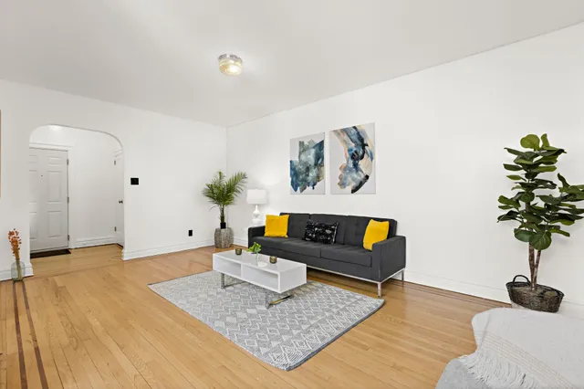 a living room with furniture and a potted plant