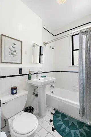a bathroom with a sink a toilet and a bathtub