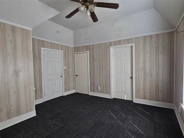 a view of an empty room and wooden floor