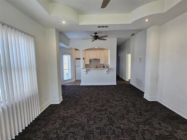 en open kitchen with granite countertop a sink and dishwasher a stove top oven with wooden floor