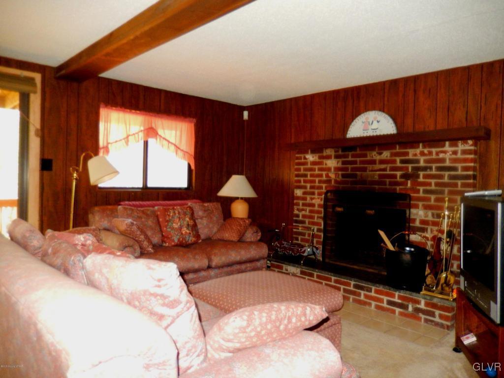 6122 Decker Road Bushkill, PA 18324 - Photo 12 of 33 a living room with furniture a fireplace and a window