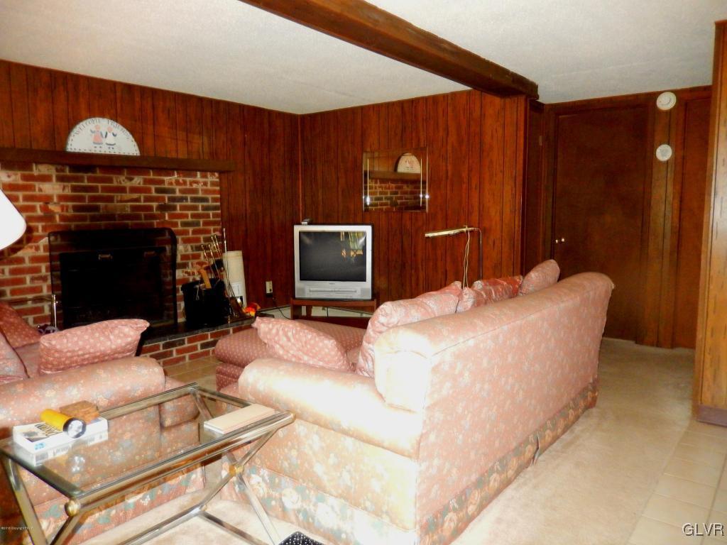 6122 Decker Road Bushkill, PA 18324 - Photo 13 of 33 a living room with furniture a fireplace and a flat screen tv