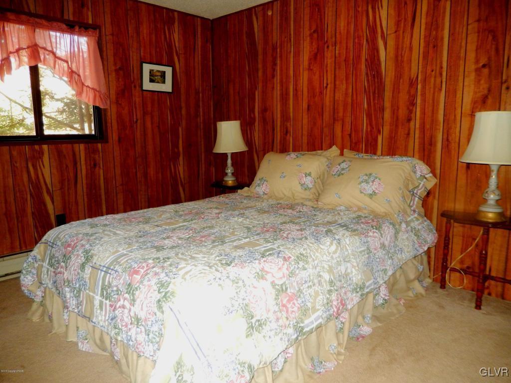 6122 Decker Road Bushkill, PA 18324 - Photo 15 of 33 a bed sitting in a bedroom next to a window