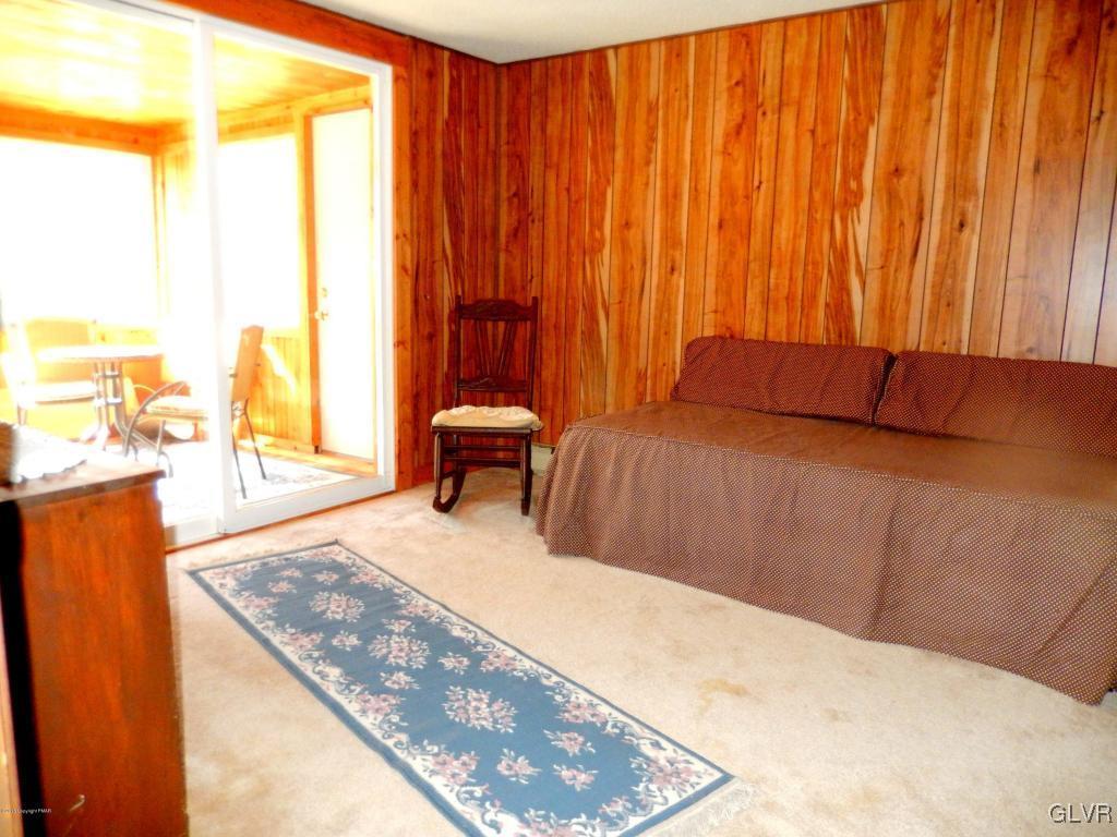 6122 Decker Road Bushkill, PA 18324 - Photo 17 of 33 a bedroom with a bed and next to a window