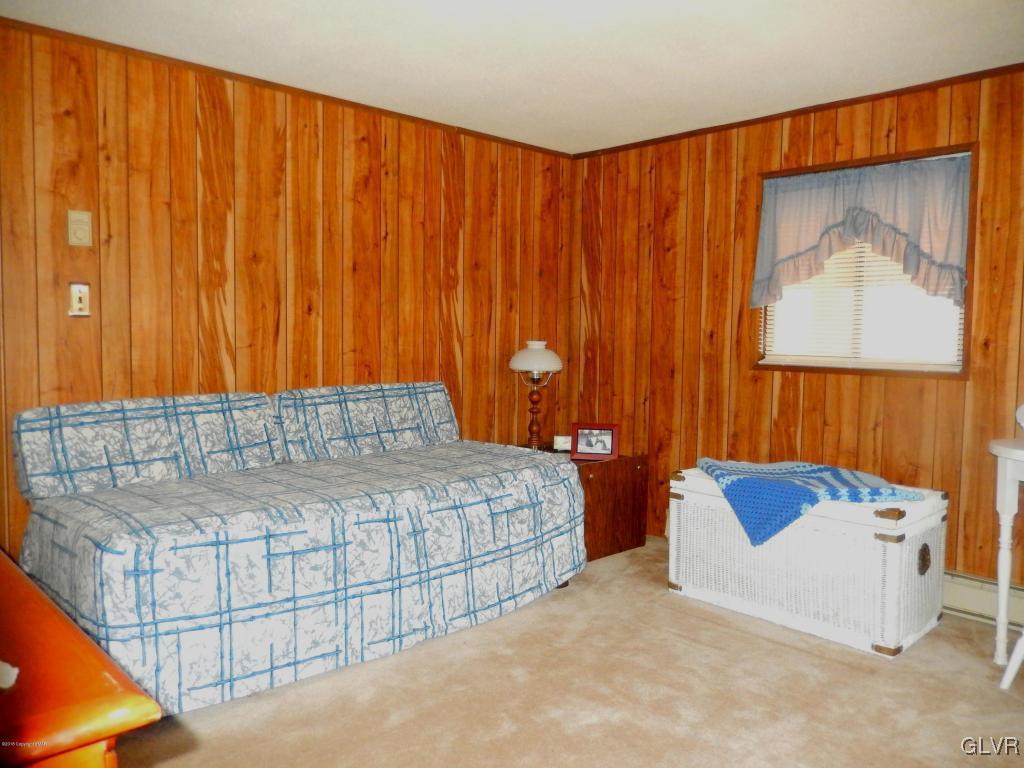 6122 Decker Road Bushkill, PA 18324 - Photo 22 of 33 a bedroom with a bed and a curtain