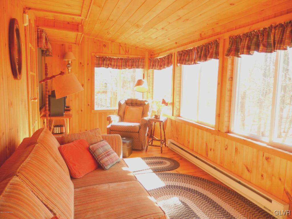 6122 Decker Road Bushkill, PA 18324 - Photo 27 of 33 a living room with blue lights furniture and a large window