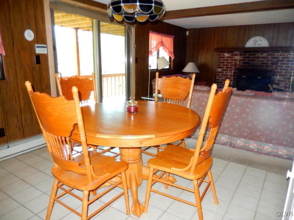 6122 Decker Road Bushkill, PA 18324 - Photo 4 of 33 a outdoor dining space with furniture and a fireplace