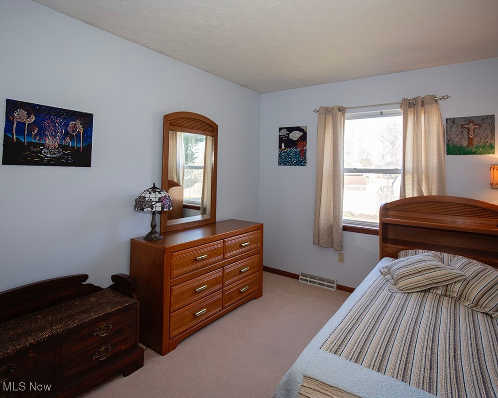 1614 South Abbe Road Elyria, OH 44035 - Photo 20 of 35 Bedroom featuring light carpet, visible vents, and baseboards