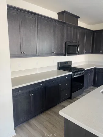 a kitchen with wooden cabinets and sink