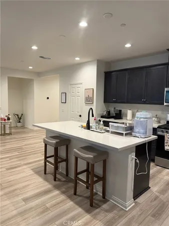 a kitchen with stainless steel appliances granite countertop a sink a stove and a refrigerator