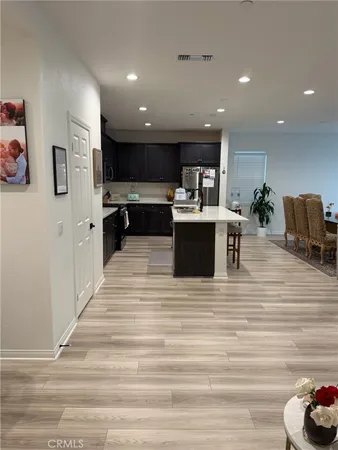 a view of a living room kitchen and a refrigerator