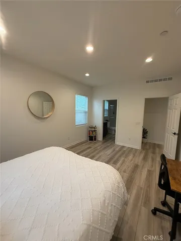 a bedroom with furniture and a window